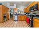 Spacious kitchen with wood cabinetry, stainless steel appliances, and tile flooring at 2903 Galena Peak Ln, Las Vegas, NV 89156