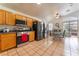 Open-concept kitchen featuring stainless appliances, tile floors, and adjacent dining area at 2903 Galena Peak Ln, Las Vegas, NV 89156