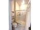 Bathroom with a step in shower, white toilet, and small storage shelf at 2925 Big Green Ln, Las Vegas, NV 89134
