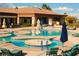 Resort-style pool area with sun loungers and umbrellas, perfect for relaxation and recreation at 2925 Big Green Ln, Las Vegas, NV 89134