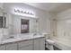 Bright bathroom with double sinks, granite countertop and tub with shower at 3058 Tarpon Dr # 103, Las Vegas, NV 89120