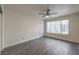 Bright bedroom features stylish gray wood flooring, large window and modern ceiling fan at 3058 Tarpon Dr # 103, Las Vegas, NV 89120