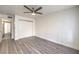 This spacious bedroom features stylish gray wood flooring and a modern ceiling fan at 3058 Tarpon Dr # 103, Las Vegas, NV 89120