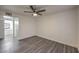 Bedroom with gray wood flooring and ceiling fan, leads to en-suite bathroom at 3058 Tarpon Dr # 103, Las Vegas, NV 89120