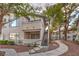 Well-kept condo building with mature trees, landscaping, and private stairway at 3058 Tarpon Dr # 103, Las Vegas, NV 89120