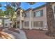 Well-maintained condo exterior with mature trees, landscaping, and private entrance at 3058 Tarpon Dr # 103, Las Vegas, NV 89120