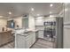 Modern kitchen with stainless steel appliances, granite countertops, and white cabinets at 3058 Tarpon Dr # 103, Las Vegas, NV 89120