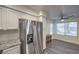 Bright kitchen with stainless steel refrigerator and modern white cabinets at 3058 Tarpon Dr # 103, Las Vegas, NV 89120