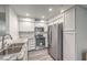 Bright kitchen with stainless steel appliances and white cabinetry at 3058 Tarpon Dr # 103, Las Vegas, NV 89120