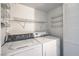 Laundry room with washer, dryer and wire shelves at 3058 Tarpon Dr # 103, Las Vegas, NV 89120