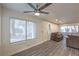 Inviting living room featuring a ceiling fan, large window, and cozy furniture at 3058 Tarpon Dr # 103, Las Vegas, NV 89120