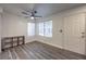 This living room features stylish gray wood flooring, a large window and a modern ceiling fan at 3058 Tarpon Dr # 103, Las Vegas, NV 89120