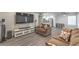 Spacious living room featuring modern gray floors and a large entertainment center at 3058 Tarpon Dr # 103, Las Vegas, NV 89120