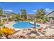 Community pool with lounge chairs and umbrellas, surrounded by mature landscaping at 3058 Tarpon Dr # 103, Las Vegas, NV 89120