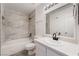 Tiled bathtub and shower featuring updated fixtures and bright lighting at 3151 Soaring Gulls Dr # 1145, Las Vegas, NV 89128