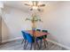 Dining area with modern lighting, a square table, and four stylish blue chairs, creating a cozy space at 3151 Soaring Gulls Dr # 1145, Las Vegas, NV 89128