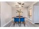 Bright dining area featuring a modern table, blue chairs, and a large window offering plenty of natural light at 3151 Soaring Gulls Dr # 1145, Las Vegas, NV 89128