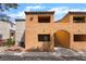 Inviting condo featuring a stucco exterior, tiled roof, and well-maintained landscaping at 3151 Soaring Gulls Dr # 1145, Las Vegas, NV 89128