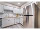 Bright kitchen features white cabinets, stainless steel appliances, and ample counter space for cooking and meal preparation at 3151 Soaring Gulls Dr # 1145, Las Vegas, NV 89128
