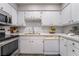 Bright kitchen features white cabinets, stainless steel appliances, and quartz countertops at 3151 Soaring Gulls Dr # 1145, Las Vegas, NV 89128