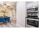 Modern kitchen with stainless steel oven, microwave and view of dining area at 3151 Soaring Gulls Dr # 1145, Las Vegas, NV 89128
