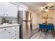 Kitchen featuring stainless steel refrigerator, white cabinets, and adjacent dining area at 3151 Soaring Gulls Dr # 1145, Las Vegas, NV 89128