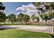 Outdoor basketball court surrounded by green grass and trees in a community at 3151 Soaring Gulls Dr # 1168, Las Vegas, NV 89128