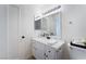 Clean bathroom with white vanity, mirror, modern lighting, and neutral tile flooring at 3151 Soaring Gulls Dr # 1168, Las Vegas, NV 89128