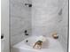 Bathroom featuring a soaking tub with tile surround and sleek, dark fixtures at 3151 Soaring Gulls Dr # 1168, Las Vegas, NV 89128