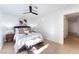 Comfortable bedroom features tile floors, a ceiling fan, and a cozy bed with decorative pillows at 3151 Soaring Gulls Dr # 1168, Las Vegas, NV 89128