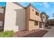 Neutral-colored apartment exterior featuring rock landscaping and windows with a glimpse of greenery at 3151 Soaring Gulls Dr # 1168, Las Vegas, NV 89128