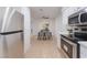 Well-lit kitchen showcases stainless steel appliances and white cabinets, leading into the dining area at 3151 Soaring Gulls Dr # 1168, Las Vegas, NV 89128