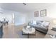 Open living room with grey sofa and view to dining area at 3151 Soaring Gulls Dr # 1168, Las Vegas, NV 89128