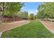 A vast green lawn in a community park with walking path and shade trees at 3636 Gainsville St, Las Vegas, NV 89129