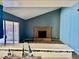Open-concept living room featuring a brick fireplace and access to the backyard at 3729 La Junta Dr, Las Vegas, NV 89120