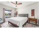 Bright bedroom with large window, ceiling fan, and modern decor at 3845 Wiggins Bay St # 202, Las Vegas, NV 89129