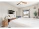 Bedroom featuring contemporary furnishings, sleek ceiling fan, and large windows offering ample natural light at 3845 Wiggins Bay St # 202, Las Vegas, NV 89129
