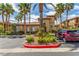 Exterior of the tan clubhouse with landscaping and parking at 3845 Wiggins Bay St # 202, Las Vegas, NV 89129