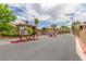 Community entrance with security gate and lush landscaping at 3845 Wiggins Bay St # 202, Las Vegas, NV 89129