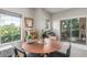 Cozy dining area with natural light, modern furnishings, and easy access to a private patio at 3845 Wiggins Bay St # 202, Las Vegas, NV 89129