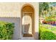 Close-up of a condo's entrance featuring a screen door, arched doorway, and a stylish doormat at 3845 Wiggins Bay St # 202, Las Vegas, NV 89129