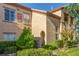 Exterior view of a well maintained condo with manicured bushes and direct access to units at 3845 Wiggins Bay St # 202, Las Vegas, NV 89129