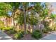 Exterior of a multi-unit building with mature trees and shrubs enhancing the curb appeal at 3845 Wiggins Bay St # 202, Las Vegas, NV 89129