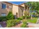 Inviting condo building exterior with well-maintained landscaping and a charming facade and visible unit numbers at 3845 Wiggins Bay St # 202, Las Vegas, NV 89129