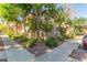 Exterior shot of a condo building showcasing lush landscaping and mature trees surrounding the property at 3845 Wiggins Bay St # 202, Las Vegas, NV 89129