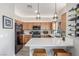 Modern kitchen with quartz counters, wood cabinets, stainless appliances, eat-in bar and stylish wine rack at 3845 Wiggins Bay St # 202, Las Vegas, NV 89129