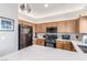 Modern kitchen featuring wooden cabinets, quartz countertops, stainless steel appliances, and contemporary lighting at 3845 Wiggins Bay St # 202, Las Vegas, NV 89129
