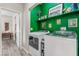 Bright laundry room featuring side-by-side washer and dryer and green shelving at 3845 Wiggins Bay St # 202, Las Vegas, NV 89129
