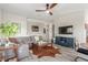 Cozy living room with gray sofa, decorative accents, a ceiling fan, and modern flooring at 3845 Wiggins Bay St # 202, Las Vegas, NV 89129