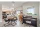 Open-concept living room with dining area and kitchen, filled with natural light and featuring modern decor at 3845 Wiggins Bay St # 202, Las Vegas, NV 89129